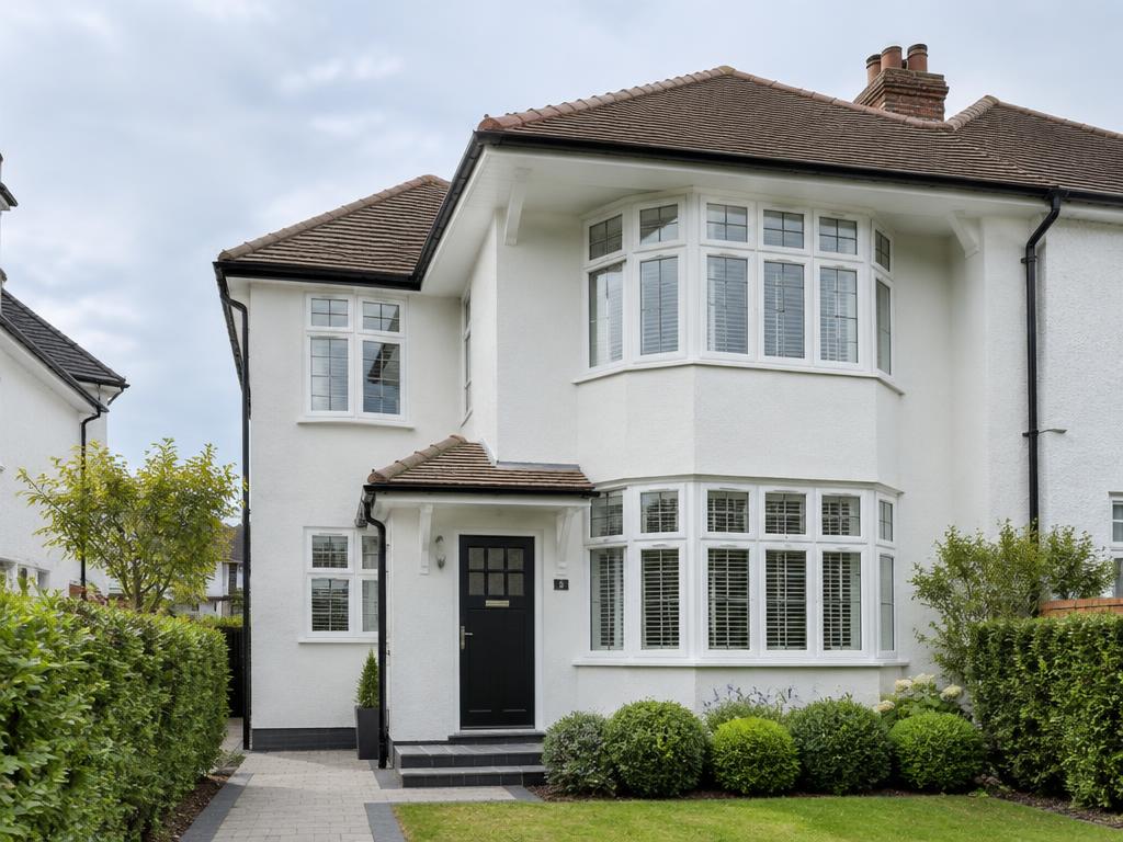 Two-storey side extension on a rendered family home