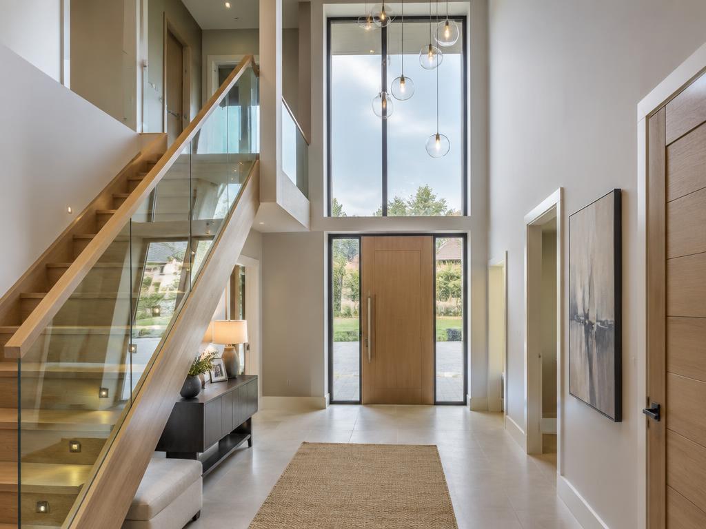 Double-height new-build hallway with oak stair