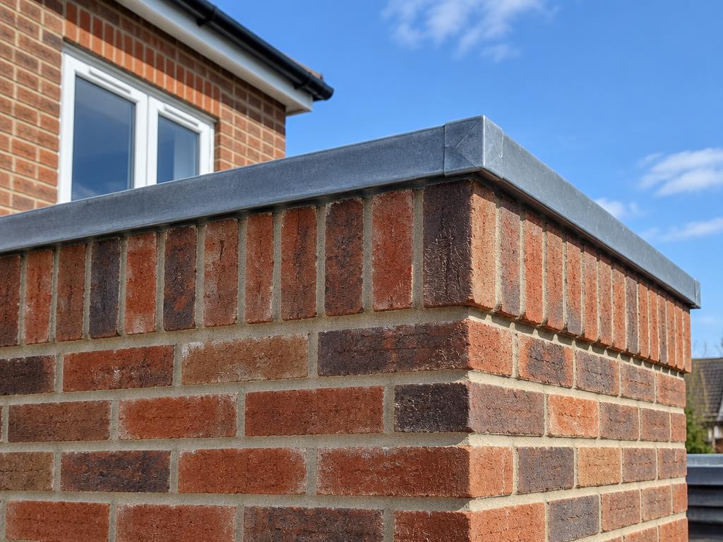 Brickwork and flashing detail on an extension parapet